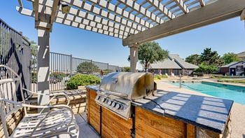 Hot tub sits under a pergola